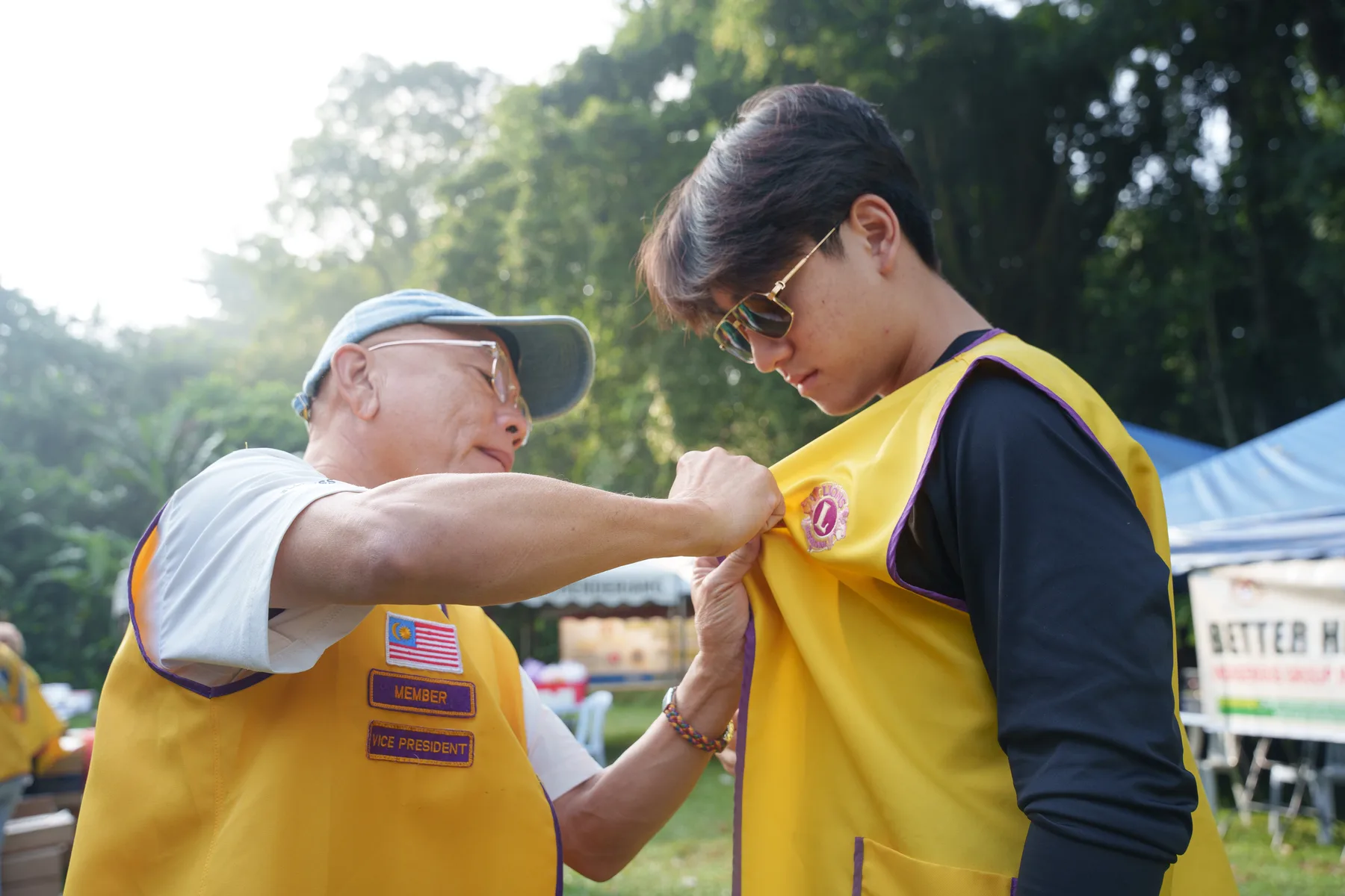 A Lions Club volunteer helping Louie prepare for the village outreach
