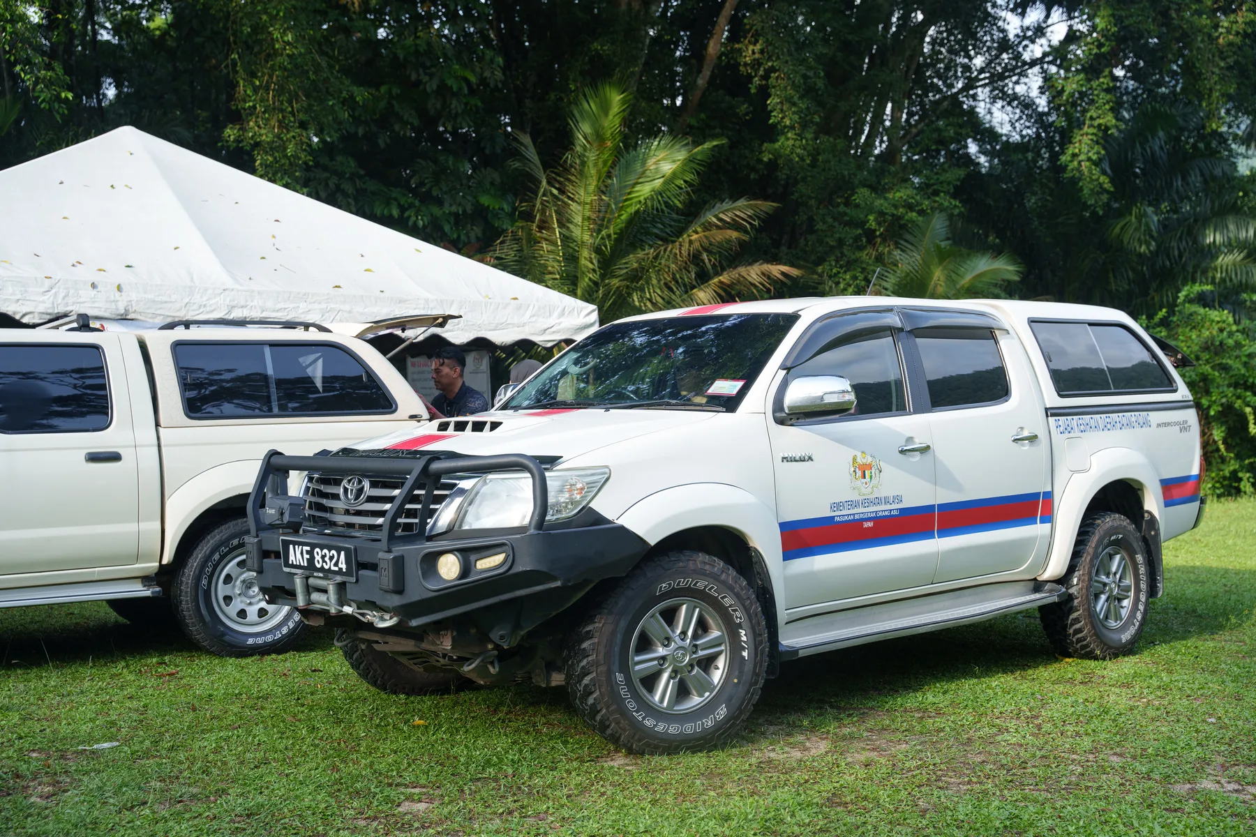 Four-wheel-drive vehicles arriving at the rural outreach site