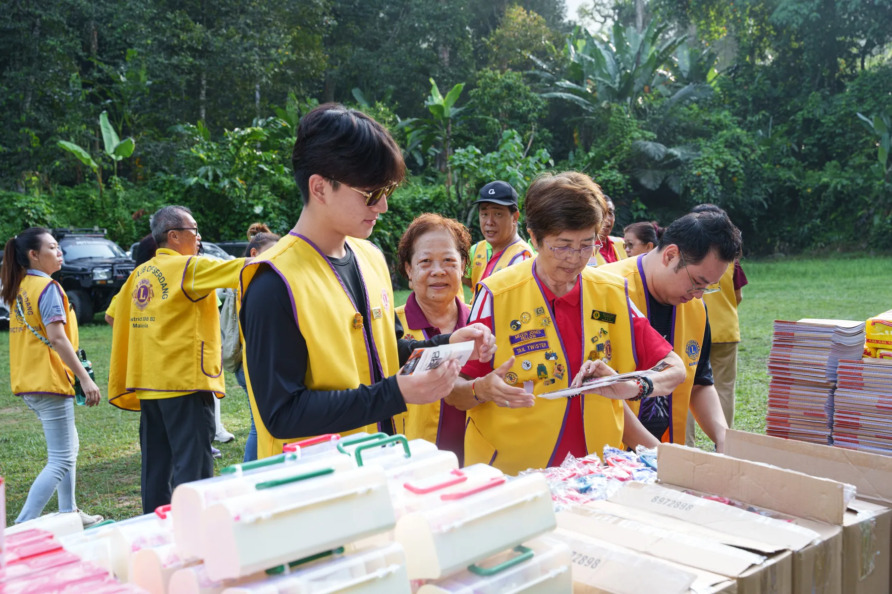 Louie and Lions Club volunteers organising medical and school supplies