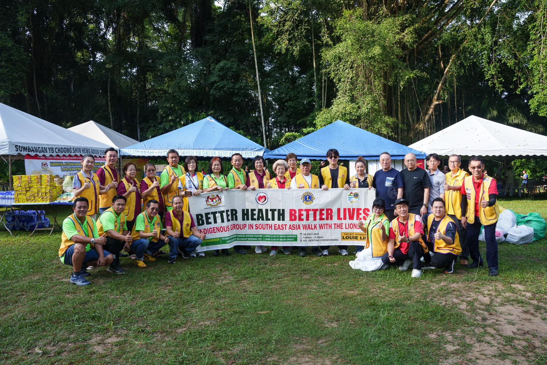 BHBL and Lions Club volunteers gathered behind the Better Health Better Lives banner