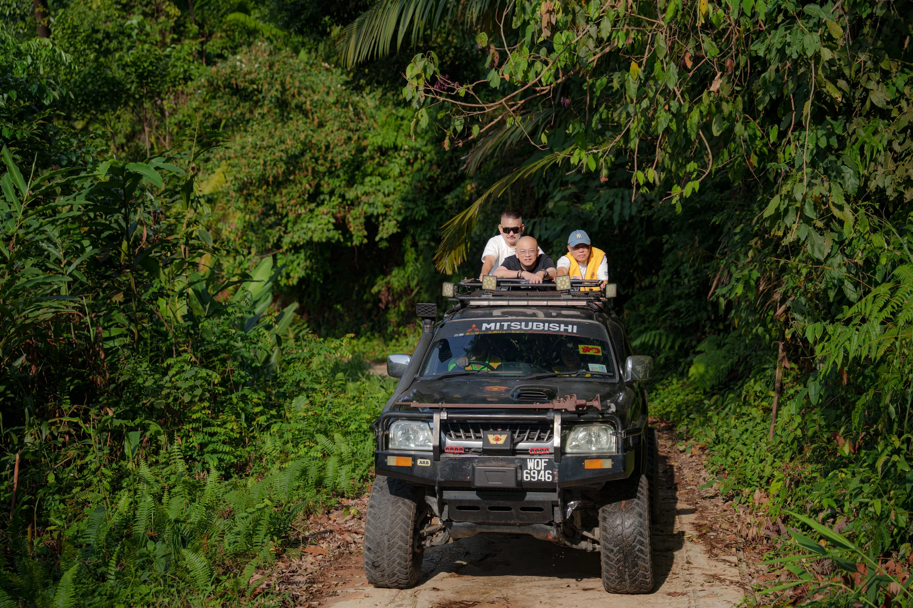 The outreach team travelling through forest terrain in a four-wheel-drive vehicle