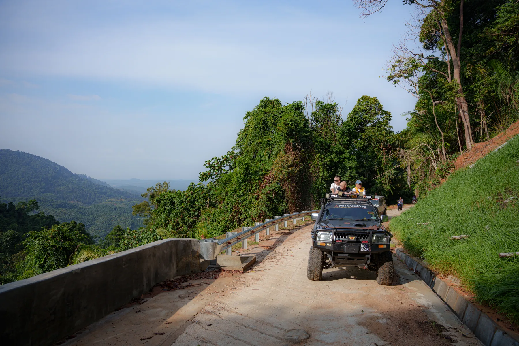 A four-wheel-drive vehicle carrying volunteers along the village road