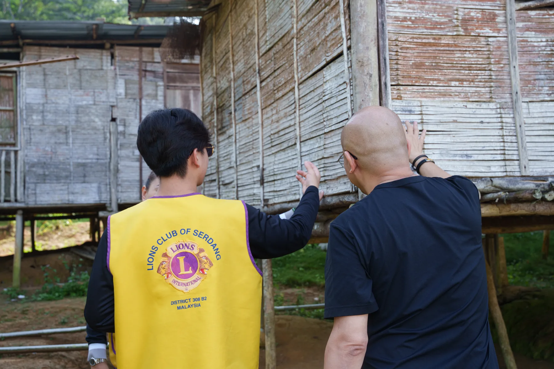 Louie and a volunteer learning about a traditional village home