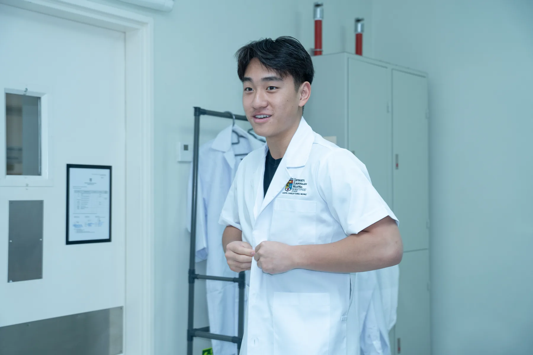 Louie wearing a laboratory coat inside the UKM research facility