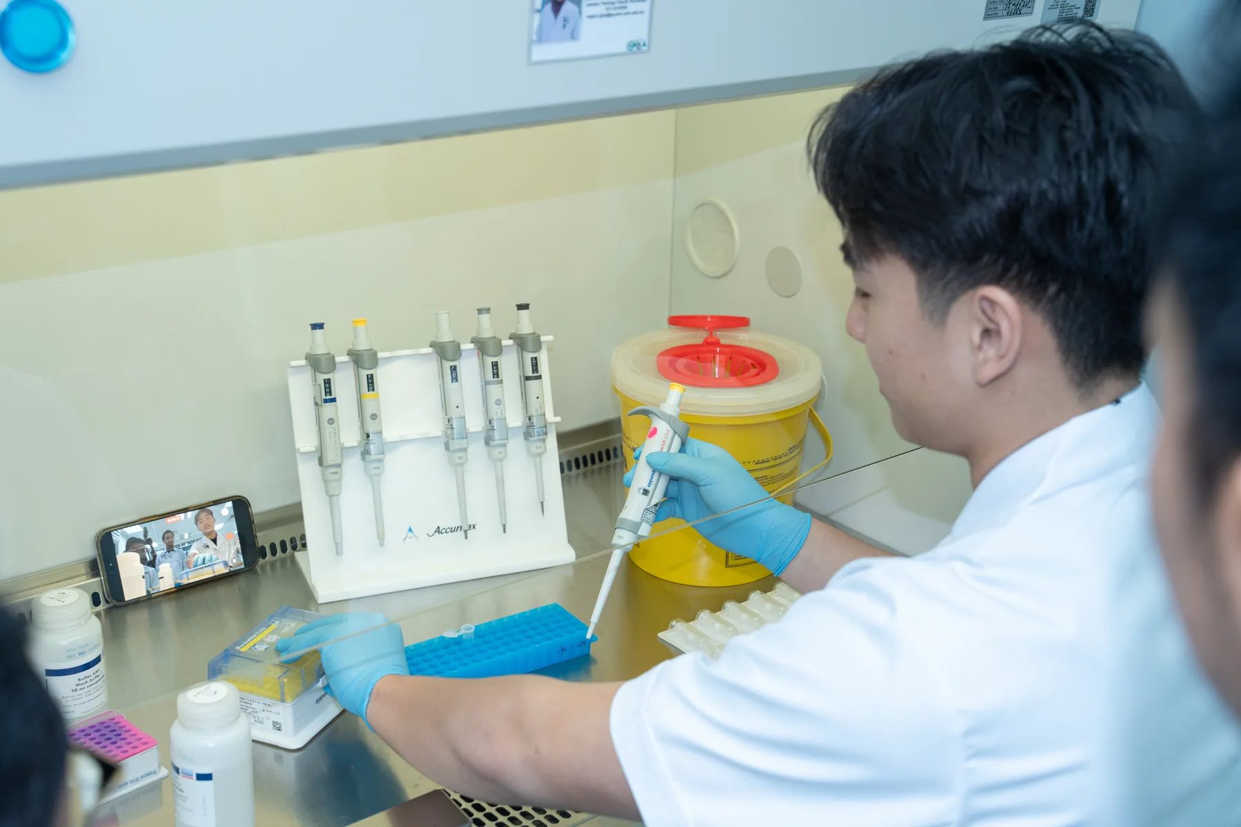Louie learning to use laboratory pipettes at a UKM workbench