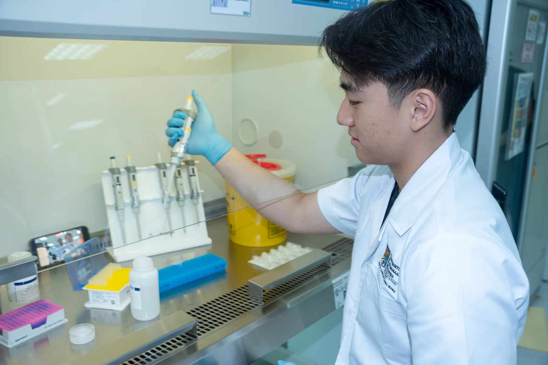 Louie preparing a sample with a laboratory pipette