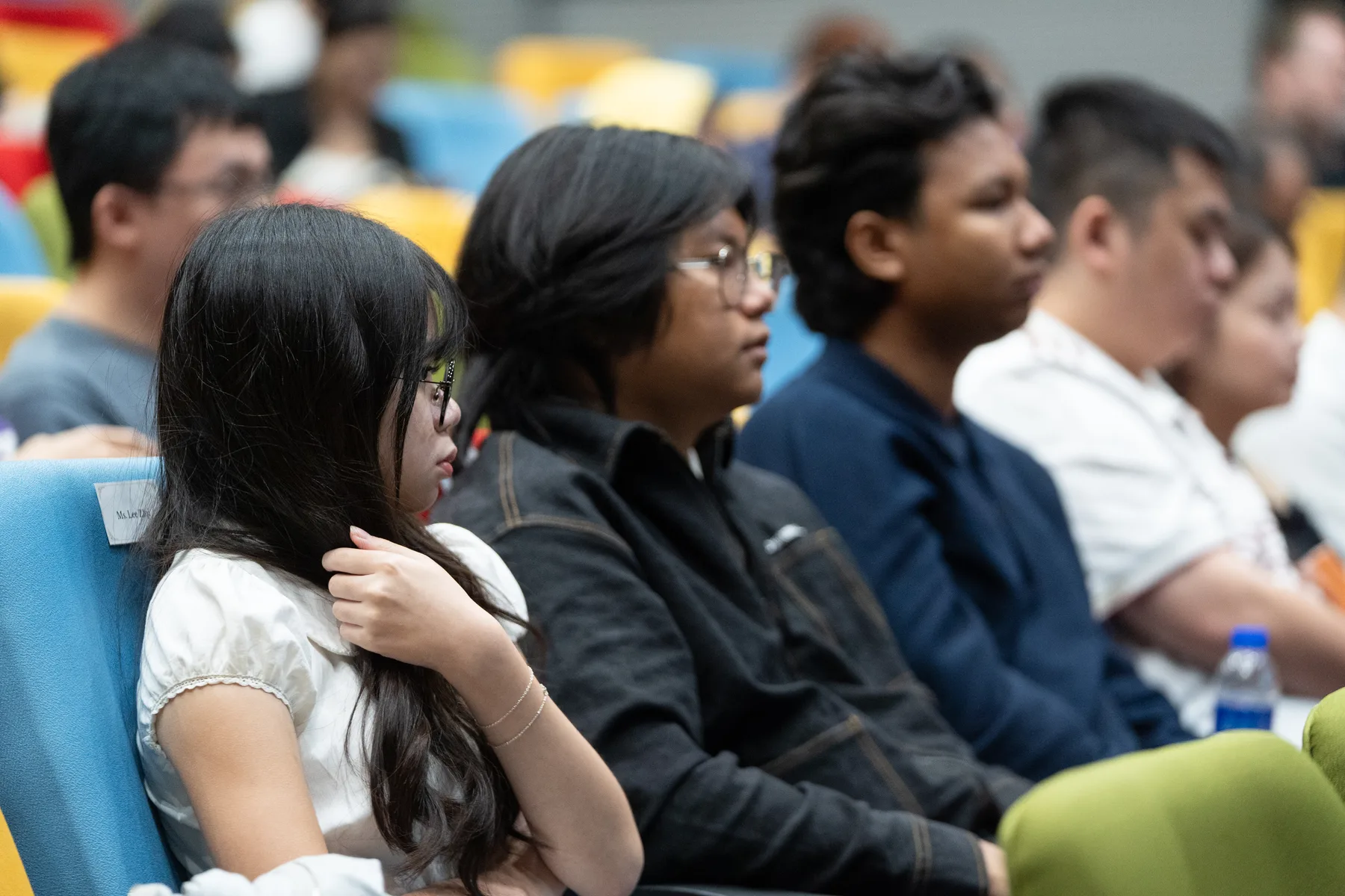 A diverse group of students listening during the UKM event