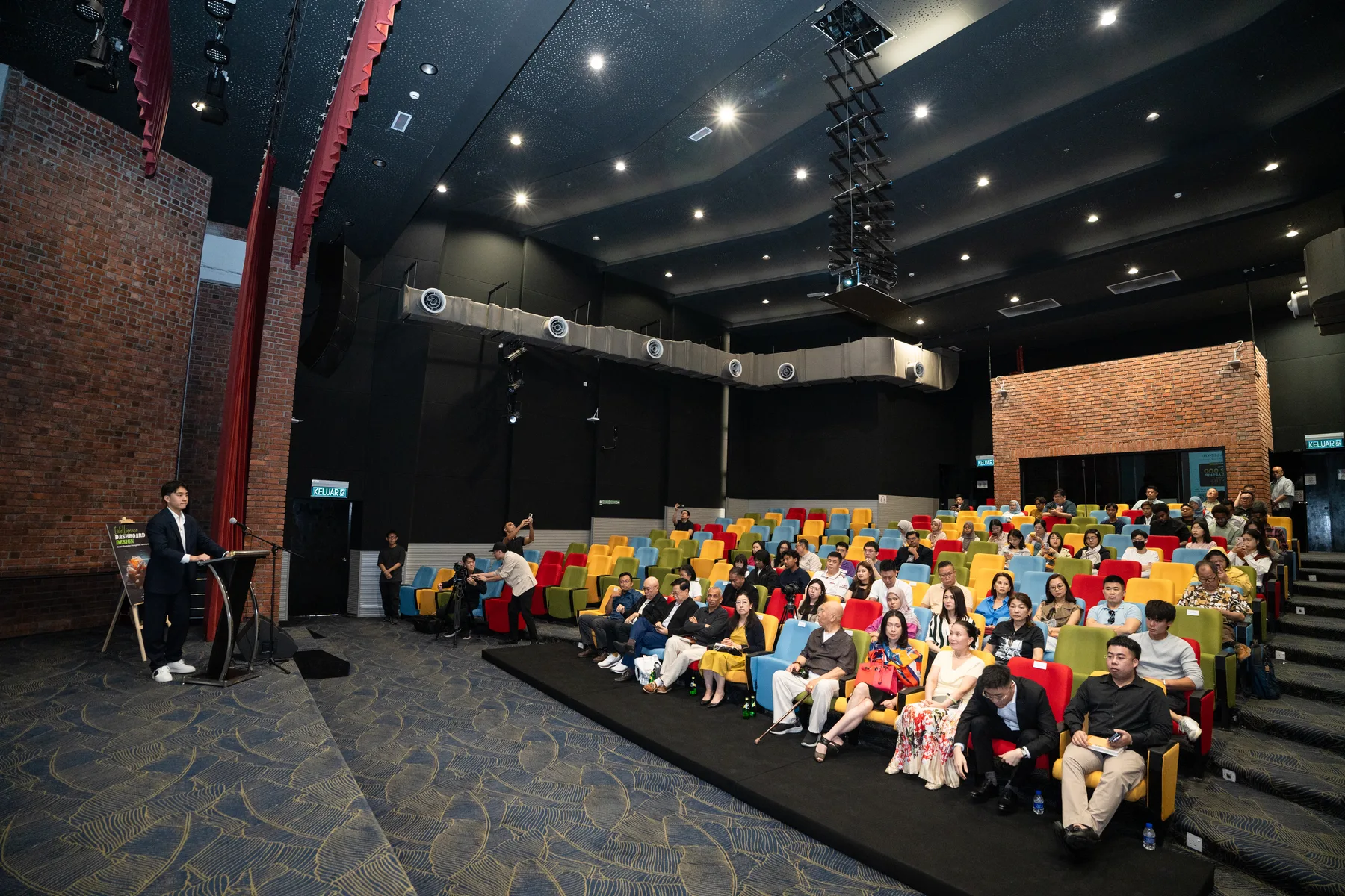 A wide view of the colourful UKM auditorium and audience