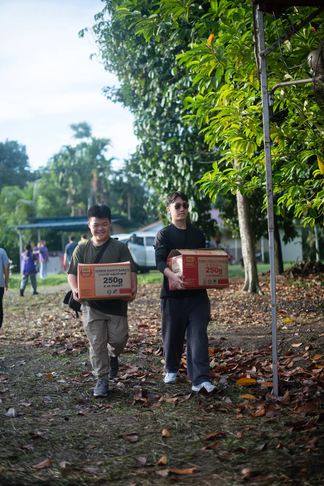 Volunteers carrying food supplies into the Orang Asli village