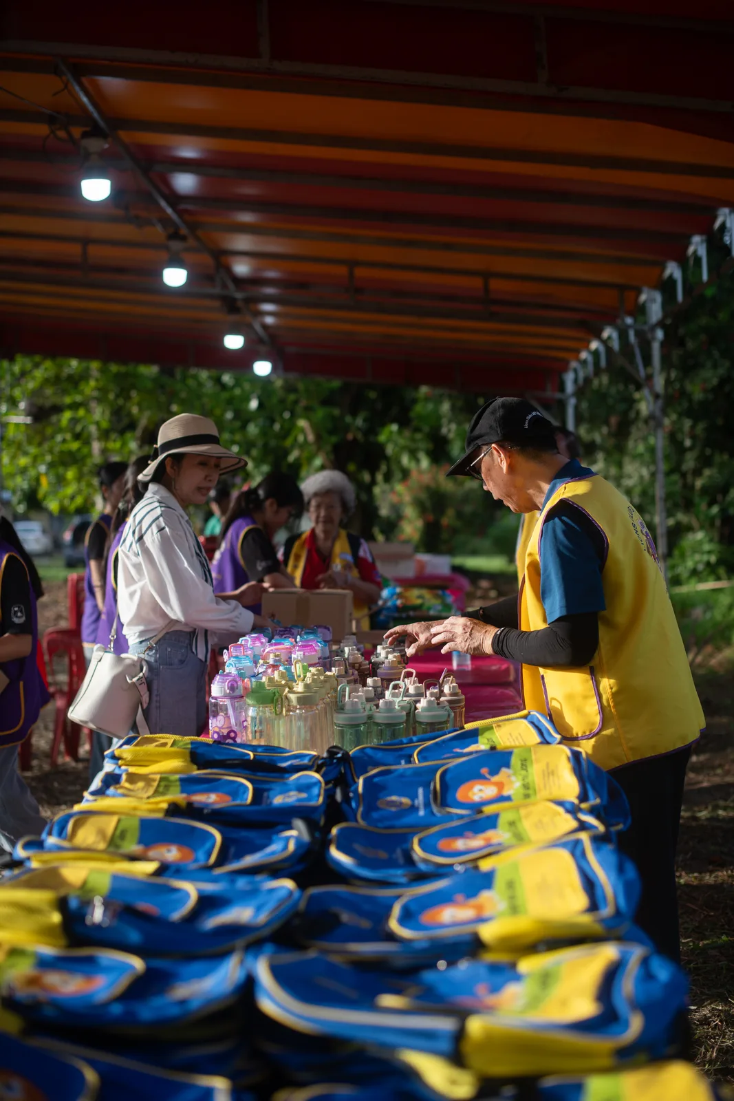 A volunteer preparing outreach materials at the village event