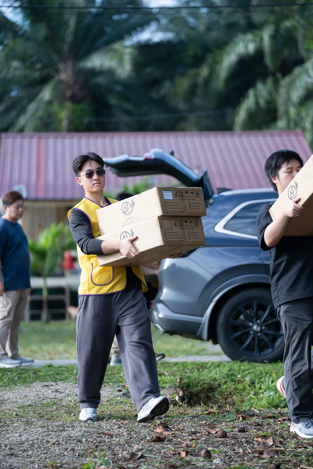A volunteer helping a child with a new school bag