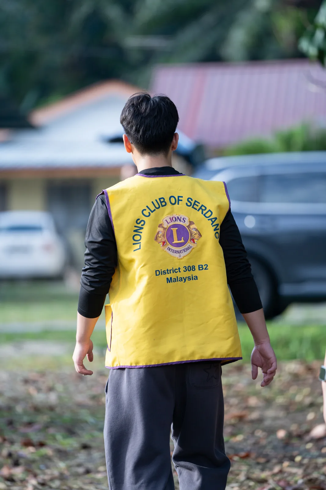 A volunteer fastening a school bag for a village child