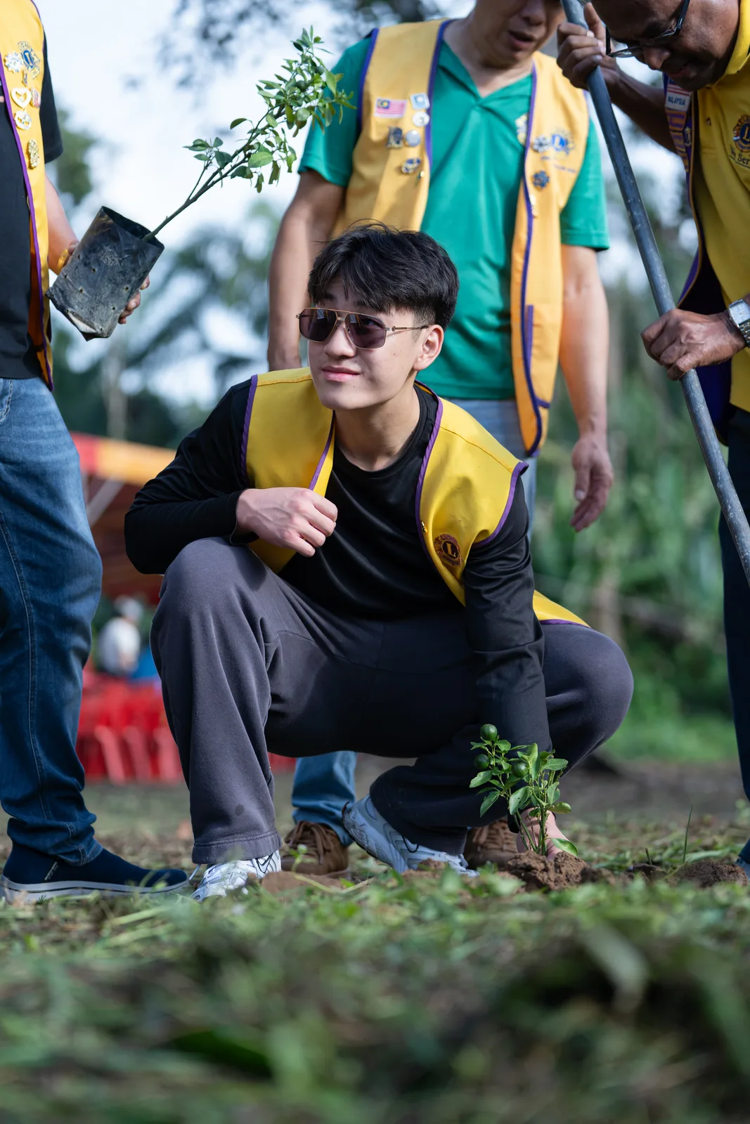 A Lions Club volunteer walking through the village outreach site