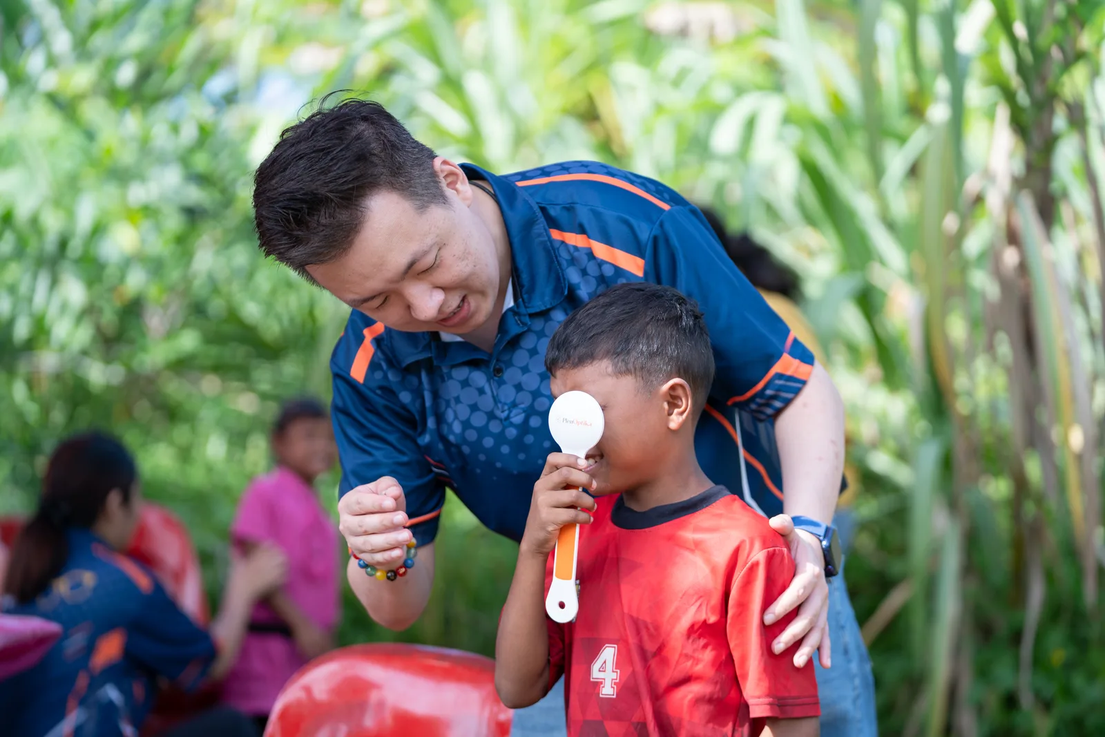 A volunteer speaking with a child during the outreach