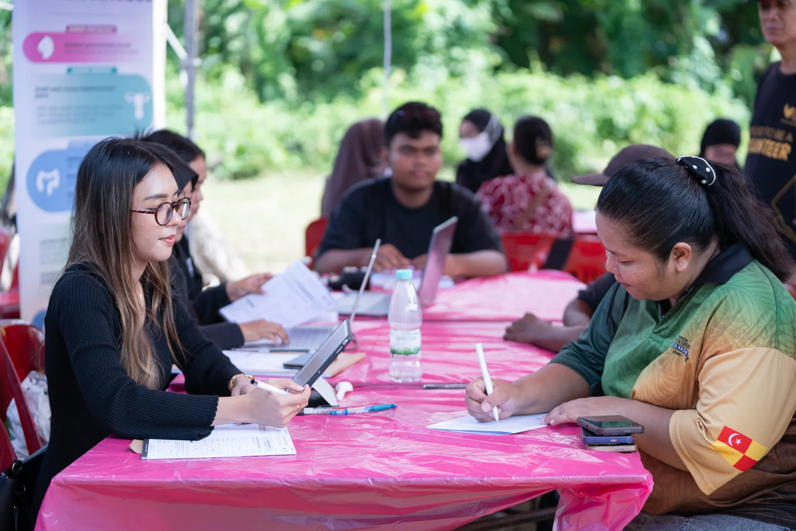Health workers registering a village resident at the outreach