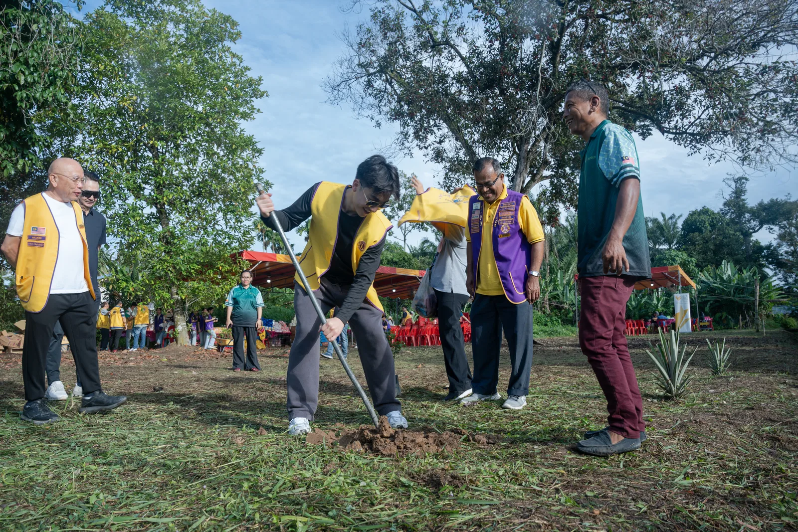 Volunteers and residents gathered beneath the programme tent